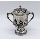 A small hallmarked silver lidded trophy