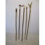 A collection of five vintage walking sticks with individual handles including a fox, swan, duck etc