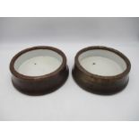 A pair of 19th century copper dog bowls with white enamelled interiors