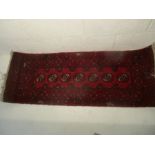 An eastern ground rug. 134cm x 52cm