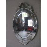 A Victorian style ornate oval mirror.
