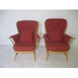 A pair of Ercol Evergreen stick back arm chairs with a pair of matching cushions.