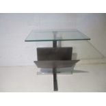 A vintage chrome and glass coffee table, with magazine rack under.