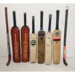 A collection of cricket bats and hockey sticks