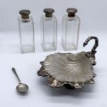 Three silver topped scent bottles along with an EPNS shell shaped dish