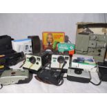 A collection of cameras, a projector and a Sony Handy Cam Video 8. Includes two Polaroid land