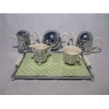 A vintage five piece Art Deco ceramic tea set with insulating chrome jackets on tray