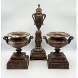 An Empire style garniture of pink marble urns with bronzed handles along with a matching lidded