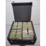 A large carry case full of 7" vinyl singles including Queen, Robert Plant, The Police, The