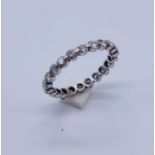 A tested 18ct white gold eternity ring set with diamonds