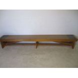 A large industrial pine bench - overall length 298cm, depth 38cm, height 44cm