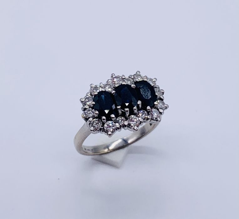 An 18ct white gold diamond and sapphire cluster ring