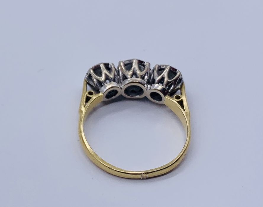 A diamond three stone ring set in 18ct gold, illusion set, the centre diamond appears to measure - Image 3 of 3