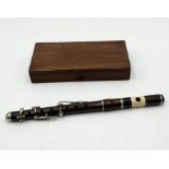 A hardwood piccolo with mismatched case