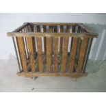 A slatted wooden industrial bobbin trolley