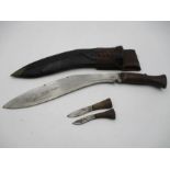 A vintage wooden handled Kukri in leather scabbard