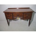 A William IV mahogany sideboard with three drawers and fan apron on turned legs