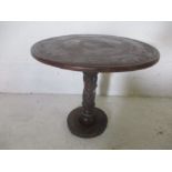 An African carved occasional table carved with various animals