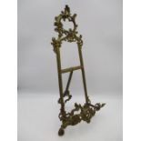 An ornate brass table easel - overall height 52cm