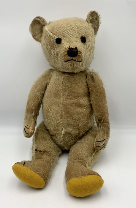 An antique straw filled plush teddy bear