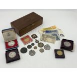 A collection of coins, banknotes and medallions including a Victoria Diamond Jubilee cross, two