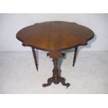 A Victorian walnut dropleaf table with shaped top