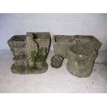 A collection of concrete garden pots and ornaments