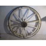 A vintage iron bound wooden cart wheel, approx 105cm diameter