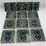 Ten full and four half William De Morgan tiles, Merton Abbey Period painted with scrolling flowers