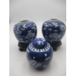 Two Chinese blue and white ginger jars on hardwood stands ( no lids) along with one other smaller