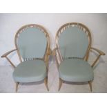 A pair of Ercol Winsor stick back armchairs.