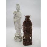A Blanc de Chine figure along with a carved wooden figure of a Deity