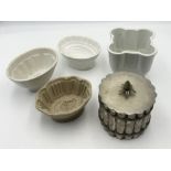A collection of ceramic and metal vintage jelly moulds