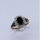 A sapphire and diamond cluster ring set in 9ct gold