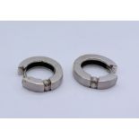 A pair of 18ct white gold earrings each set with a diamond, total weight 5.4g