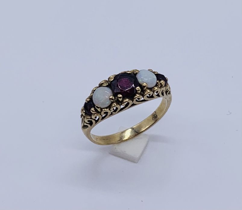 A Victorian 9ct gold garnet and opal five stone ring