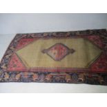 An eastern handwoven rug. 215cm x 120cm
