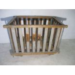 A wooden slatted industrial bobbin trolley