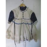 A vintage child's dress and pinafore