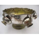 A silver plated punch bowl with six cups