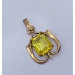 A 9ct gold Art Nouveau pendant set with a yellow sapphire (treated)