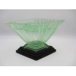 An Art Deco green glass vase on plinth