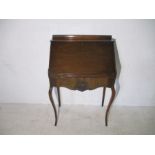 An Edwardian serpentine fronted bureau with single drawer and cabriole legs