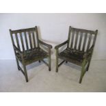 A pair of wooden weathered garden chairs