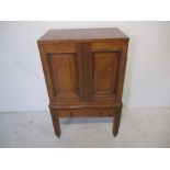 An oak cabinet with single drawer under