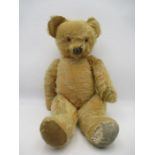 An antique teddy bear with moveable mouth ( believed to have had a pull cord to back of head-