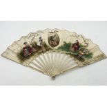 A 19th Century ivory fan with hand painted scenes, each stick ornately carved and pierced
