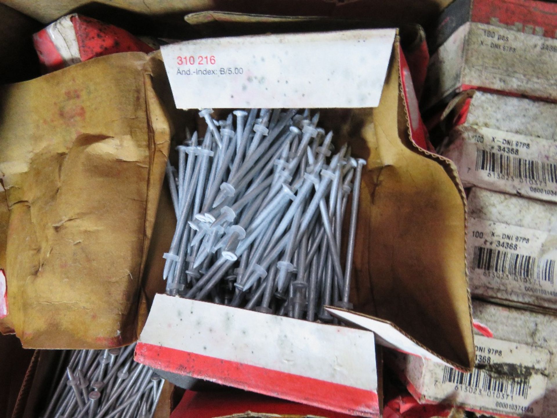 BOX CONTAINING A LARGE AMOUNT OF HILTI NAIL FIXINGS.