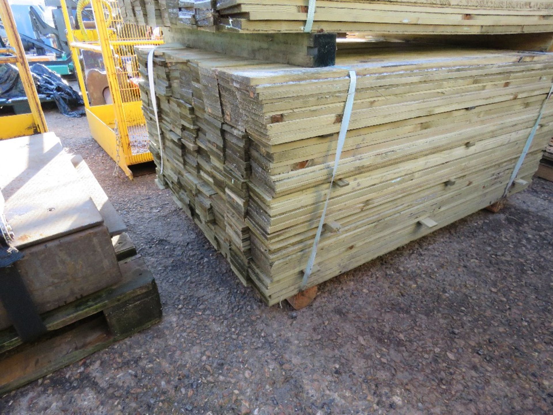 LARGE PACK OF TREATED FEATHER EDGE FENCE CLADDING TIMBERS. 1.5M X 10CM WIDTH APPROX.