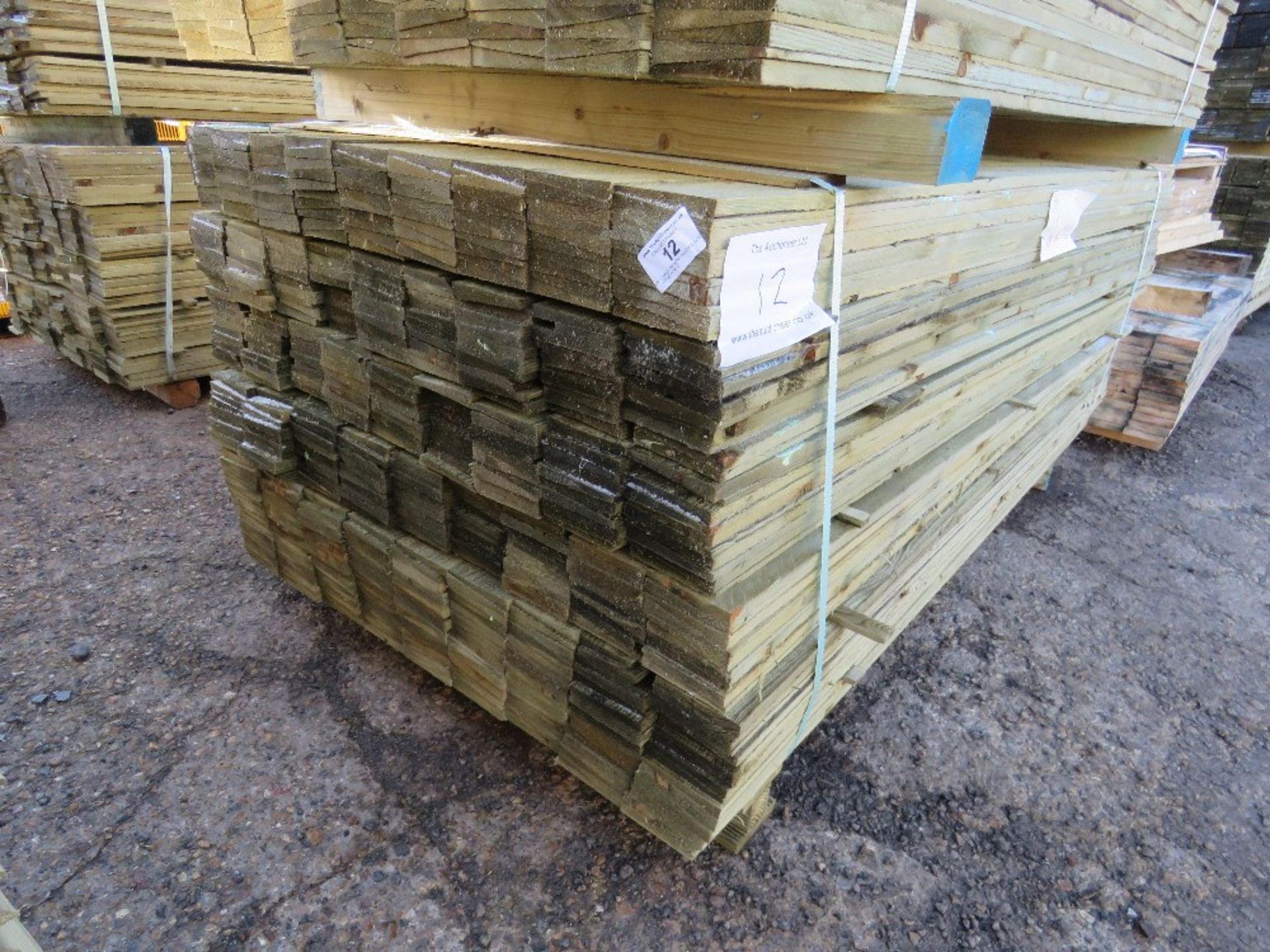 LARGE PACK OF TREATED FEATHER EDGE FENCE CLADDING TIMBERS. 1.8M X 10CM WIDTH APPROX.